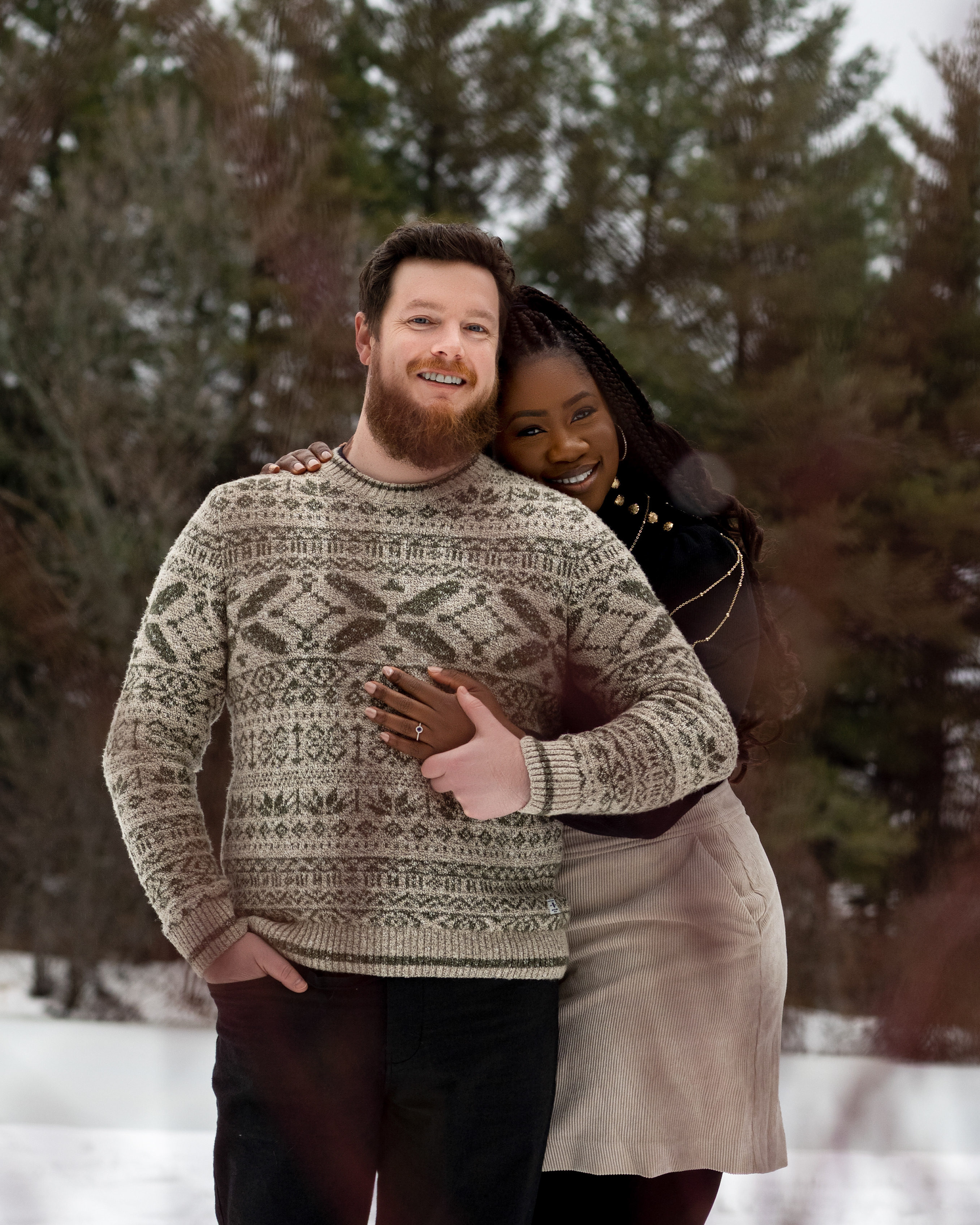 Engagement photo of Ehi hugging Andrew from behind.